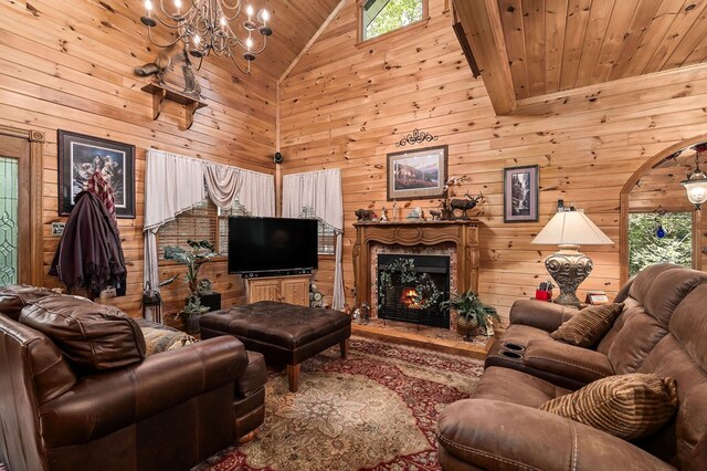 living area featuring a warm lit fireplace, wooden walls, arched walkways, wood ceiling, and high vaulted ceiling