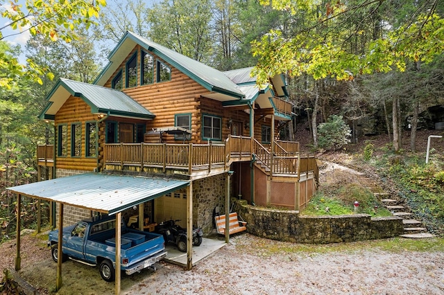 rear view of house featuring metal roof, log exterior, and stairway