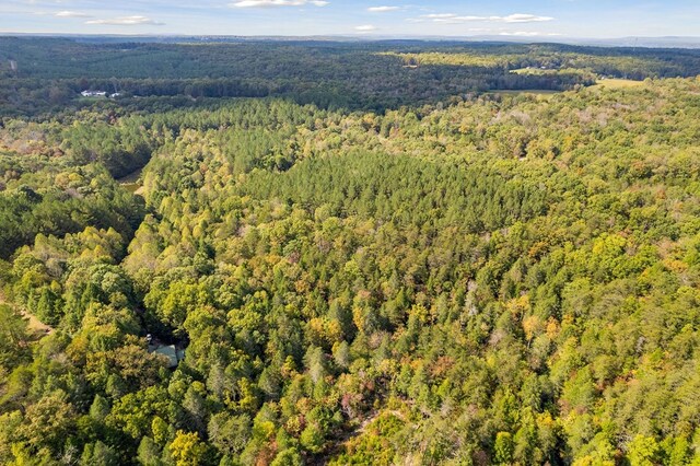 drone / aerial view featuring a forest view