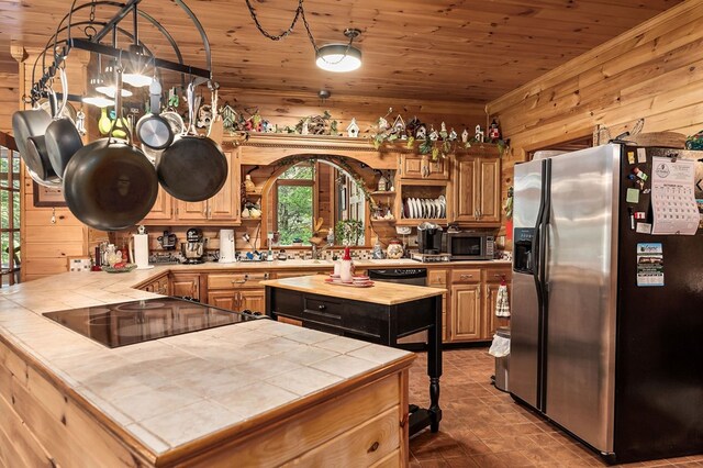 kitchen with tile countertops, wood ceiling, a kitchen island, and appliances with stainless steel finishes