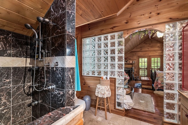 bathroom featuring a shower, french doors, wood ceiling, vaulted ceiling, and wood walls