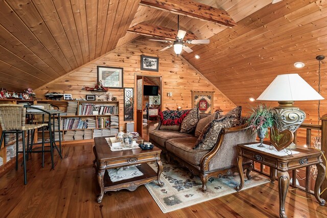 living area featuring vaulted ceiling with beams, wood finished floors, and wood ceiling