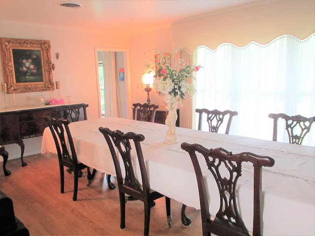 dining area with visible vents and light wood-style flooring