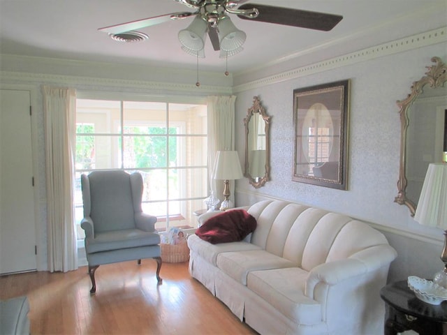 living room featuring ceiling fan, light wood finished floors, and visible vents