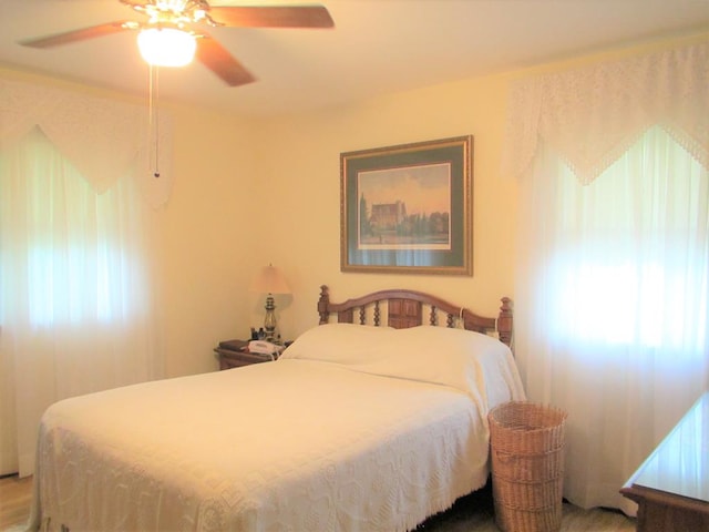 bedroom featuring ceiling fan and multiple windows