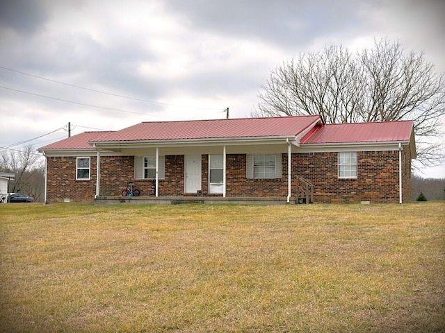 ranch-style home with crawl space, brick siding, metal roof, and a front lawn