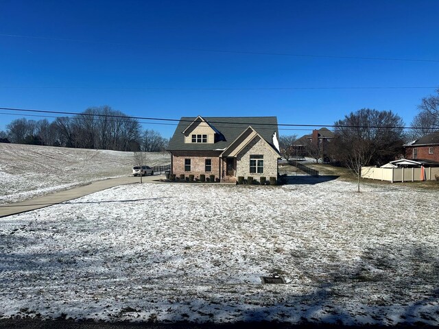 view of front of property with fence and brick siding