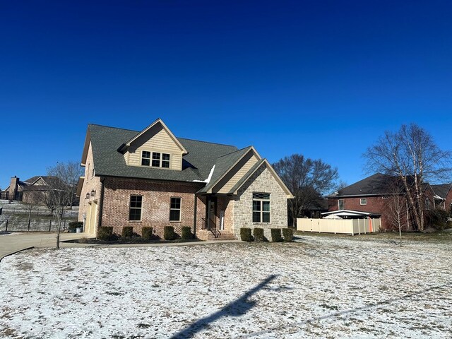 view of front of home with fence and brick siding