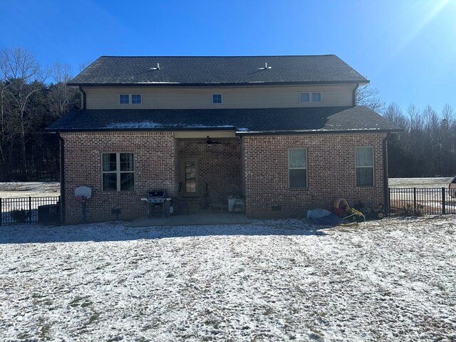 back of property with crawl space, brick siding, a patio, and fence