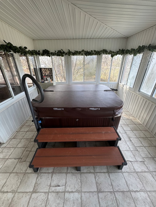 unfurnished sunroom featuring a hot tub