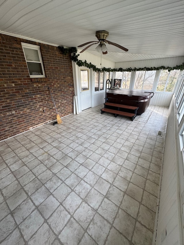 view of patio / terrace featuring a hot tub and a ceiling fan