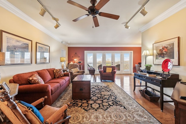 living area featuring ornamental molding, french doors, light wood-style floors, and track lighting