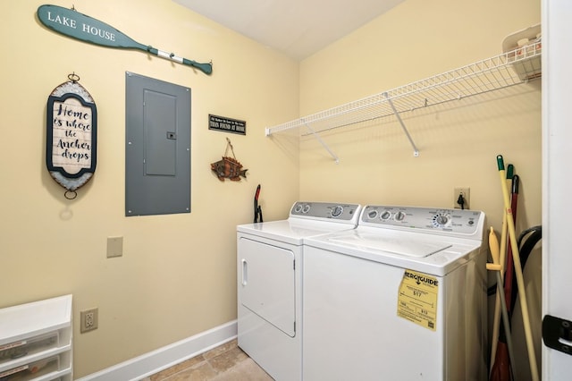 laundry room with baseboards, laundry area, electric panel, and washer and dryer