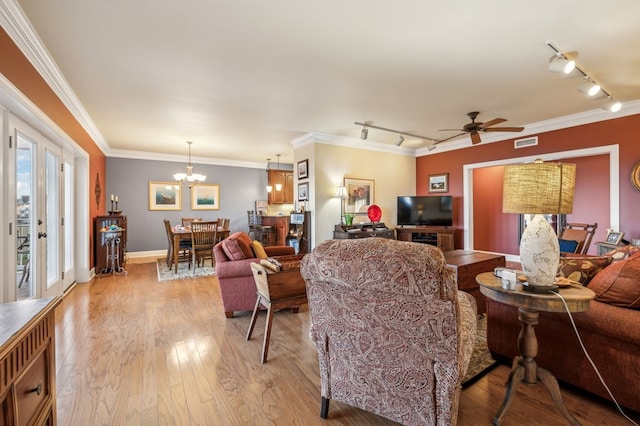 living area featuring light wood-style flooring, visible vents, and ornamental molding