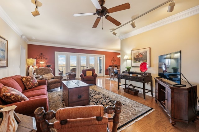 living area with french doors, ornamental molding, ceiling fan, track lighting, and wood finished floors