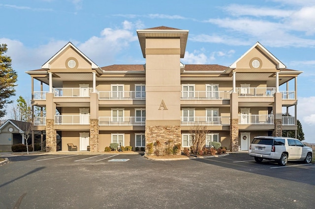 view of property with uncovered parking