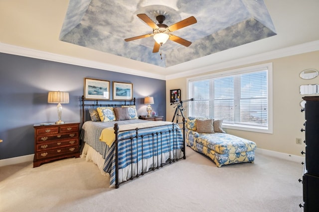 carpeted bedroom with a ceiling fan, a tray ceiling, crown molding, and baseboards