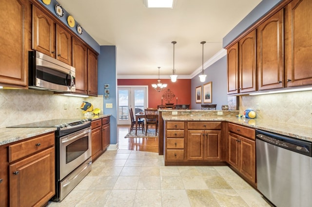 kitchen featuring pendant lighting, stainless steel appliances, brown cabinetry, light stone countertops, and a peninsula