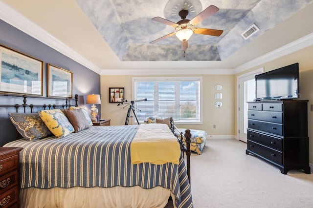 bedroom with light carpet, crown molding, visible vents, and a tray ceiling