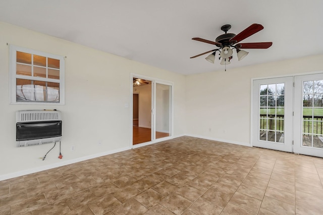 unfurnished room with heating unit, light tile patterned floors, ceiling fan, and baseboards