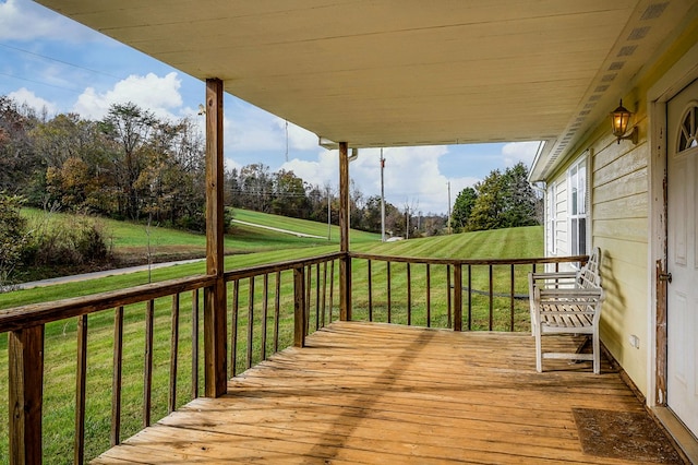 wooden terrace with a lawn