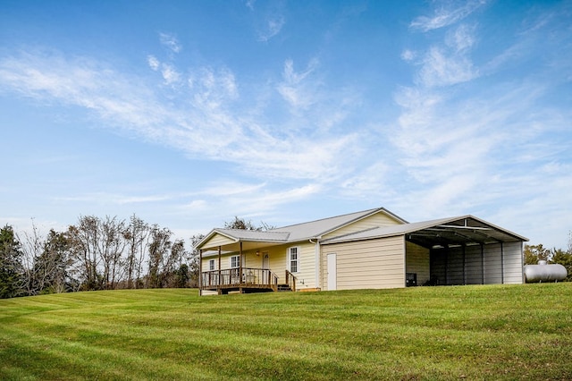 exterior space with a front yard, a deck, and a detached carport