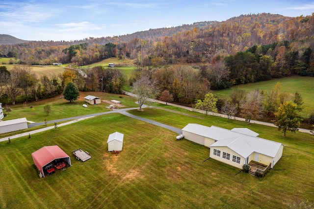 birds eye view of property featuring a view of trees