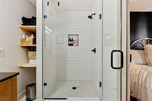 bathroom with a shower stall and vanity