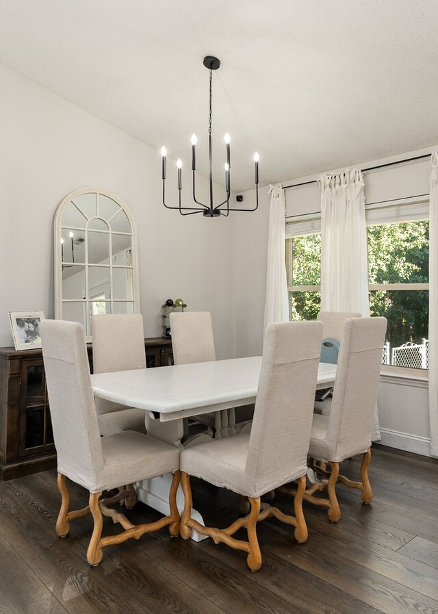 dining area featuring a chandelier and dark wood-type flooring