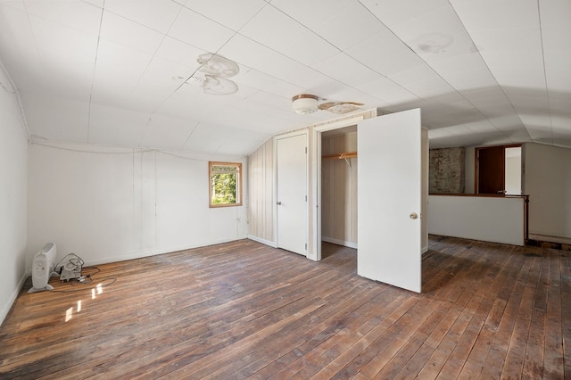 bonus room featuring dark wood-style flooring and vaulted ceiling