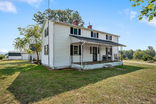 view of front of house featuring a porch, metal roof, a chimney, and a front lawn