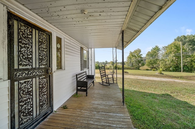 deck with covered porch and a yard