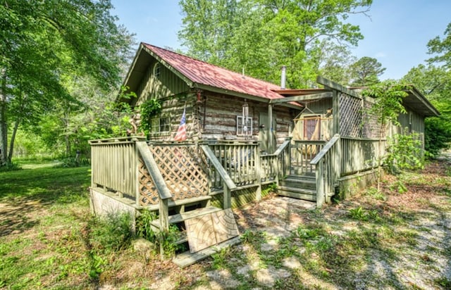 back of house with metal roof