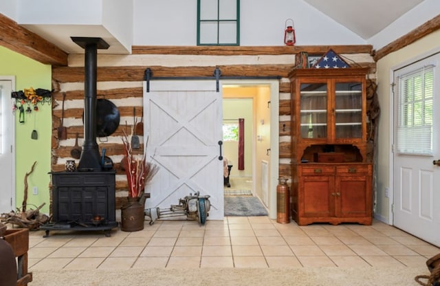 living room with light tile patterned floors, lofted ceiling, and a wood stove