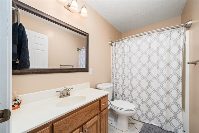 full bathroom with toilet, tile patterned flooring, a textured ceiling, and vanity