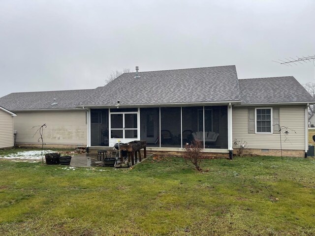 rear view of property featuring a sunroom, roof with shingles, a lawn, and crawl space