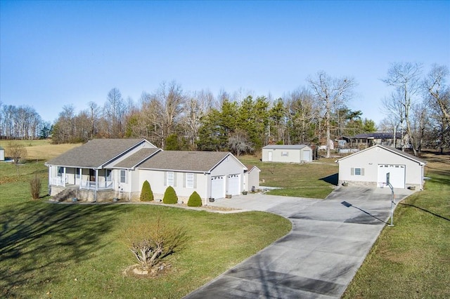 view of front of house with driveway, covered porch, a storage unit, an outdoor structure, and a front lawn