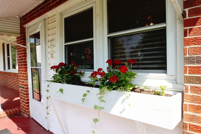 doorway to property featuring brick siding