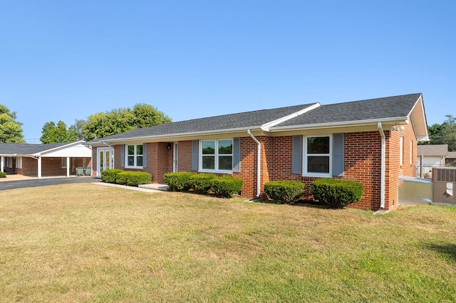 ranch-style house featuring central AC, brick siding, and a front lawn