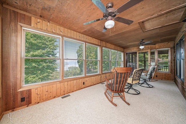 sunroom featuring wooden ceiling, visible vents, and a healthy amount of sunlight