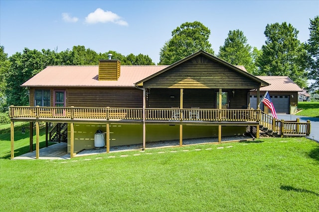 back of property featuring a yard, a chimney, stairway, metal roof, and a deck