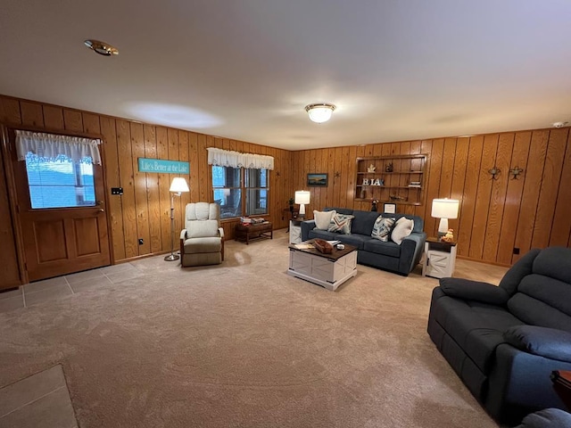 living room with light colored carpet and wood walls