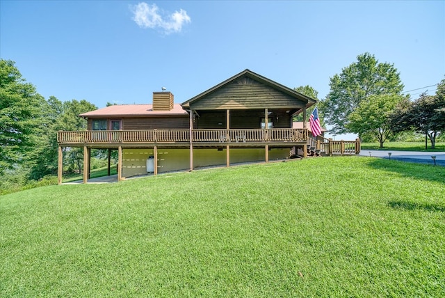 back of house with a wooden deck, a chimney, and a yard