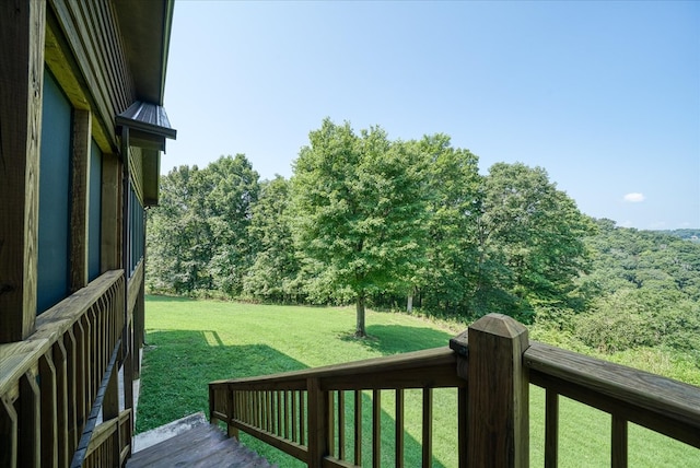 wooden deck featuring a lawn