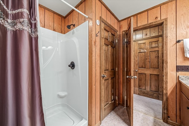 bathroom with a shower stall and wooden walls