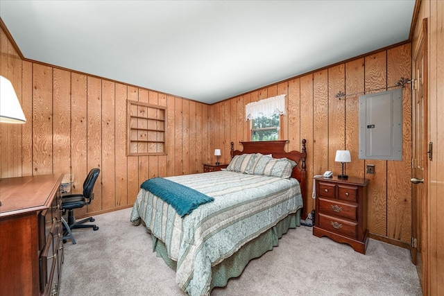 bedroom featuring wooden walls, electric panel, and light colored carpet