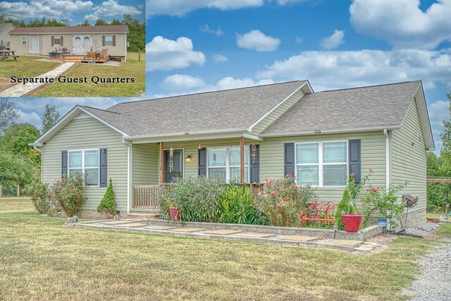 ranch-style house with a shingled roof, a front lawn, and a porch