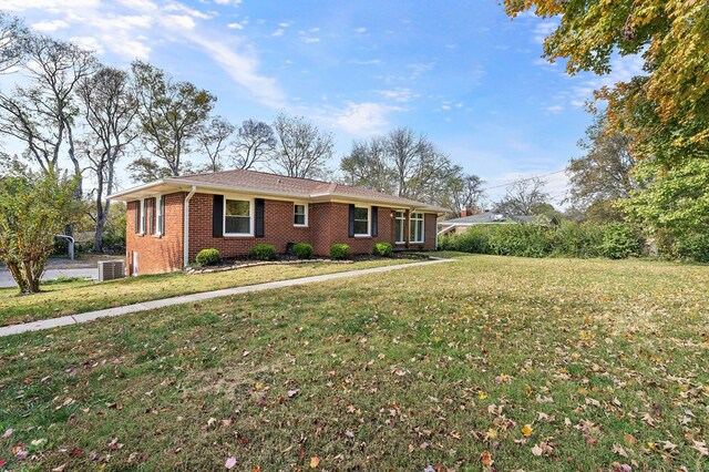 ranch-style home with a front lawn and brick siding