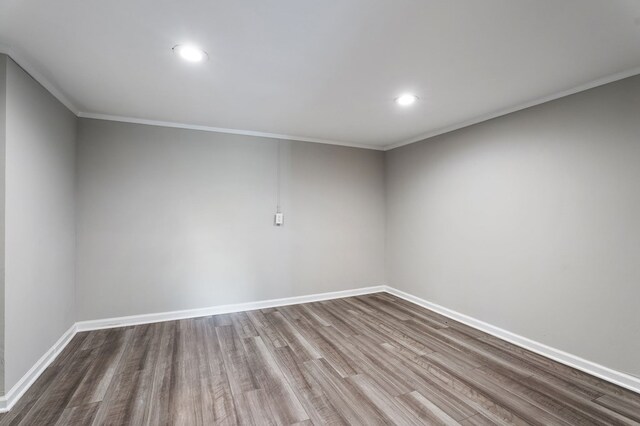 unfurnished room with crown molding, baseboards, wood finished floors, and recessed lighting