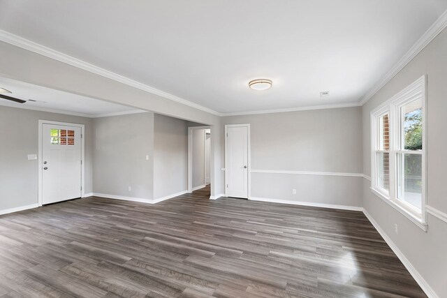 unfurnished room featuring wood finished floors, a wealth of natural light, and baseboards